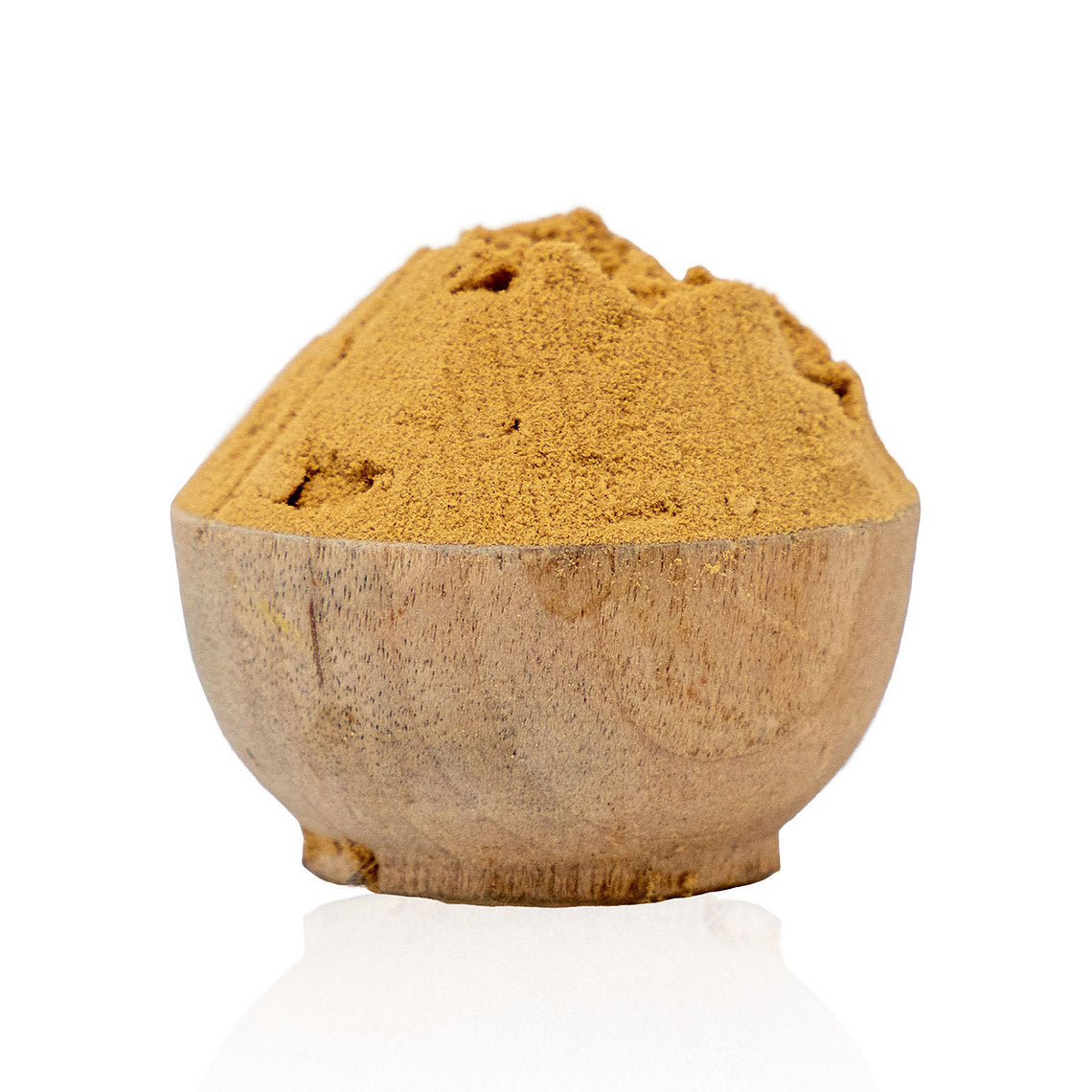 Wooden bowl filled with brown powder on a white background