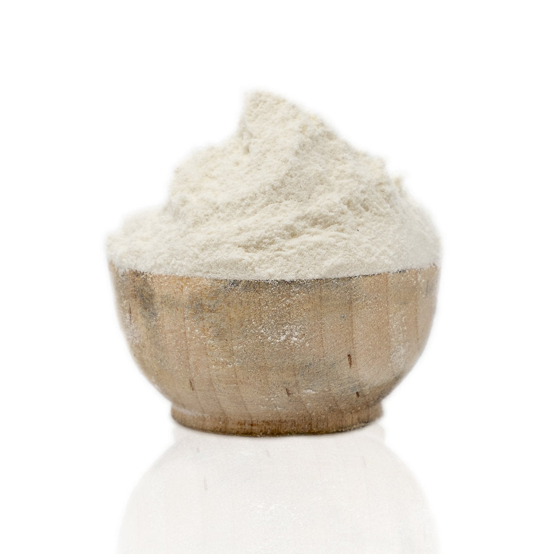 Wooden bowl filled with white powder on a white background Chalk (calcium carbonate)