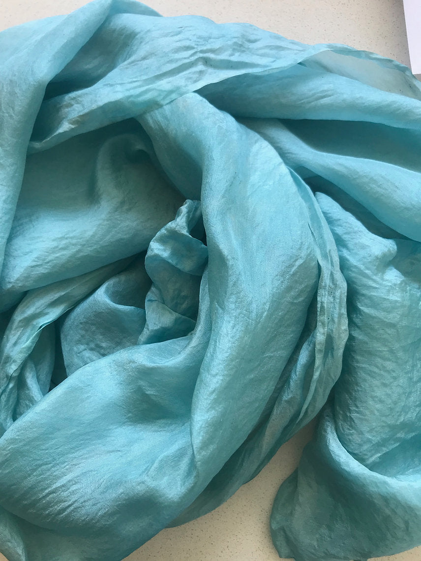 Close-up of a turquoise fabric on a light background