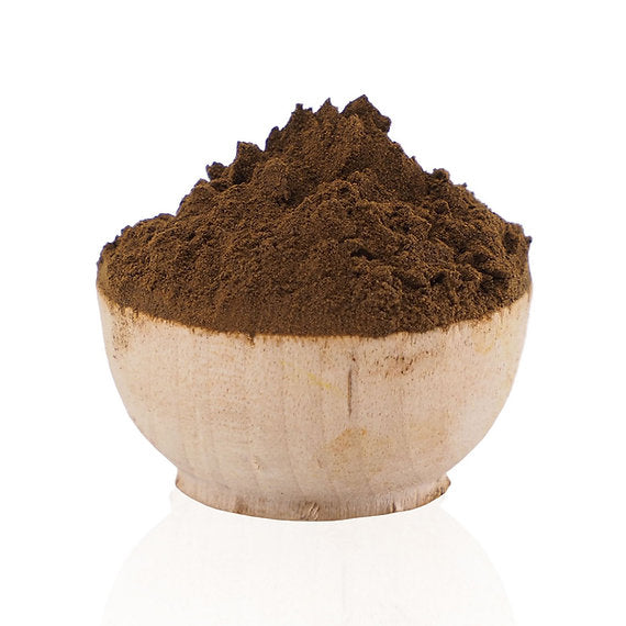 Brown powder in a wooden bowl on a white background