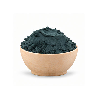 Wooden bowl filled with green powder on a white background