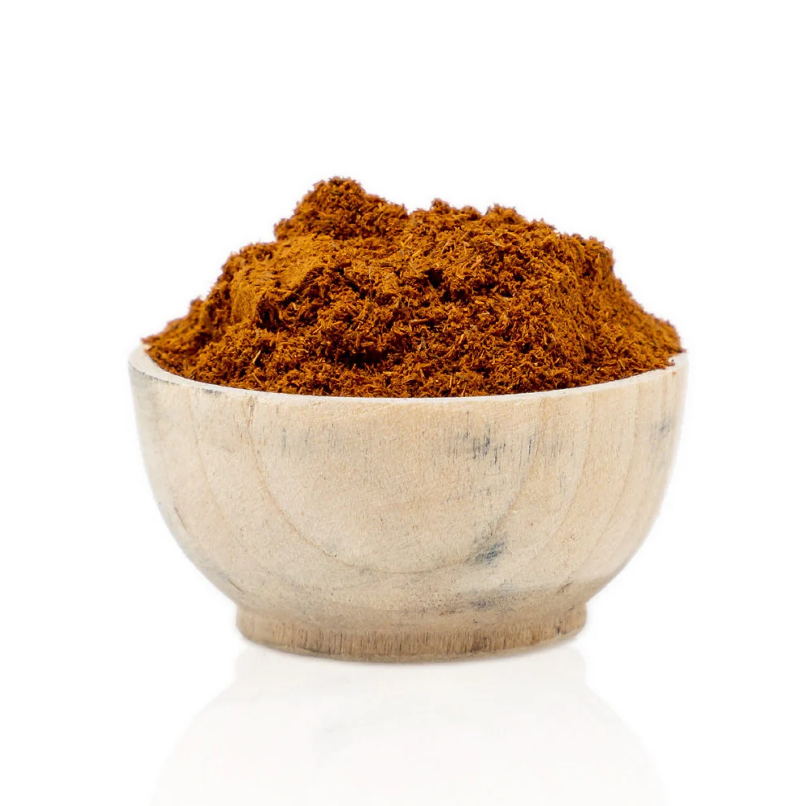 Wooden bowl filled with red powder on a white background