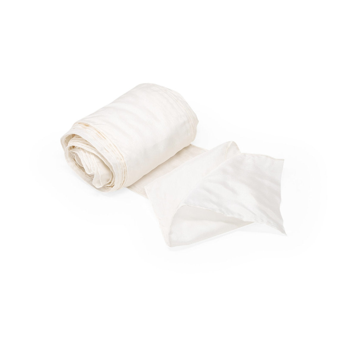 White fabric roll and folded sheet on a white background