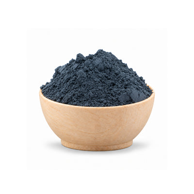 Ceramic bowl filled with dark blue Woad Powder (Isatis Tinctoria) on a white background