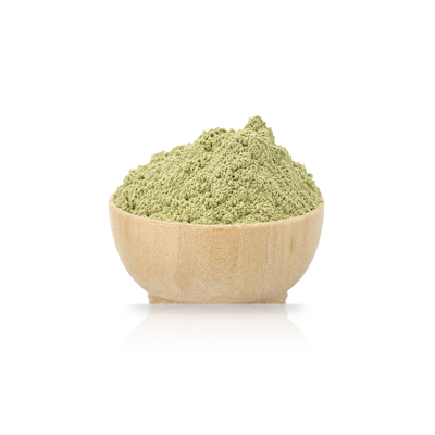 a mound of woad powder in a wooden bowl