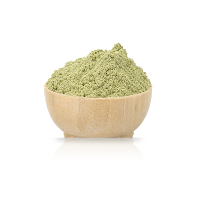 a mound of woad powder in a wooden bowl