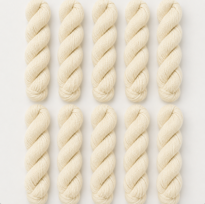 Nine skeins of cream-colored yarn arranged in a 3x3 grid on a light gray background.