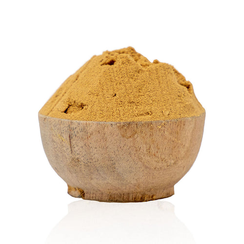 Wooden bowl filled with brown powder on a white background