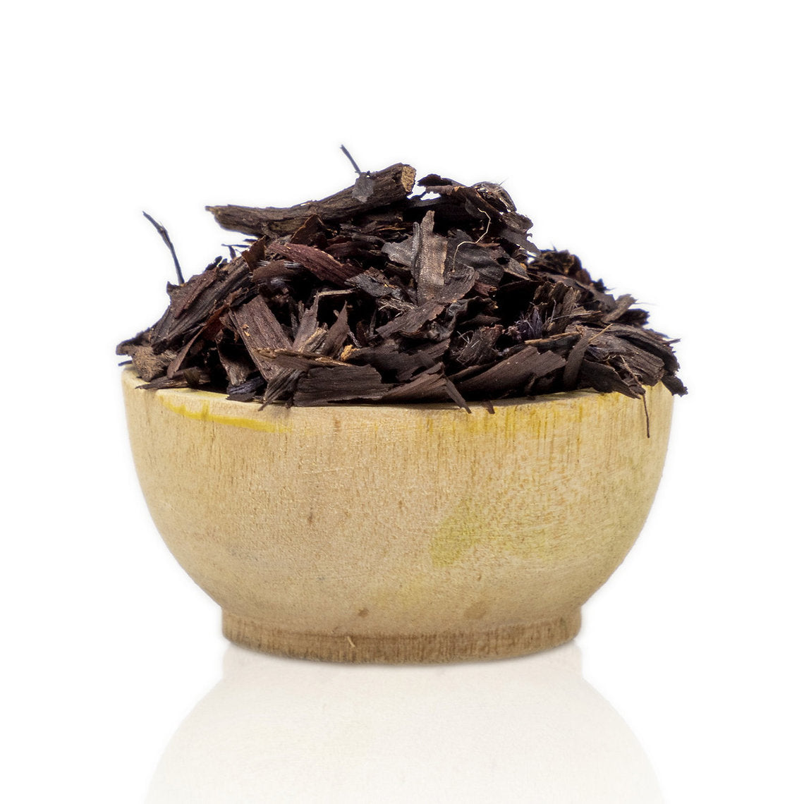 Dry black leaves Alkanet Roots (Alkanna tinctoria) organic in a wooden bowl on a white background