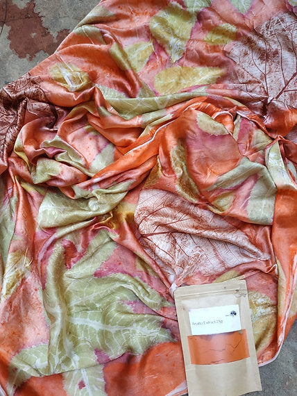 Fabric with leaf pattern and a small package on a textured surface