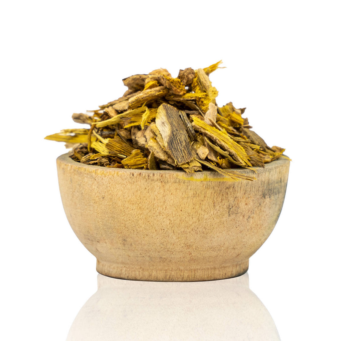 Wooden bowl filled with dried herbs on a white background