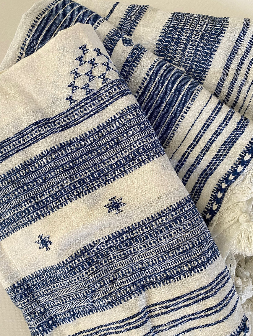 Blue and white patterned fabric with star designs on a textured background