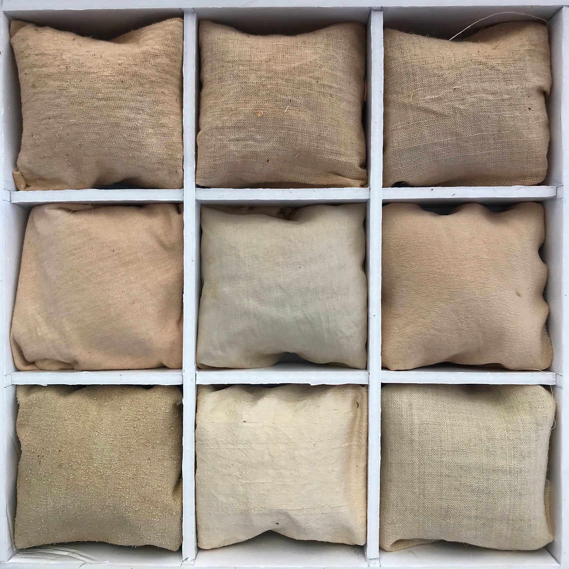 Nine beige fabric dyed Birch Bark (Betula pendula) arranged in a 3x3 grid on a white background