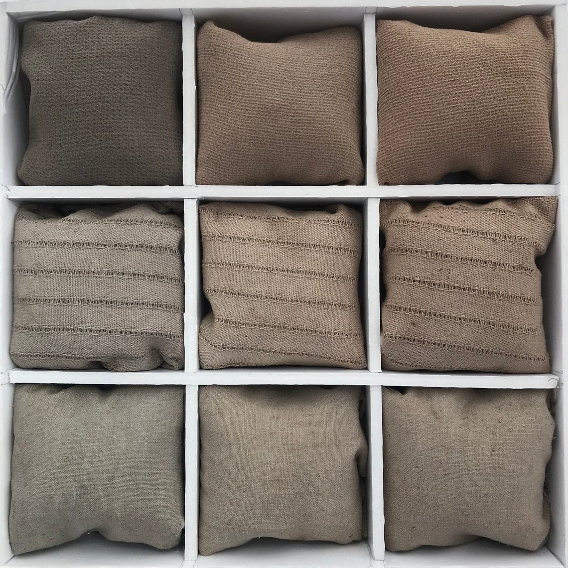 Nine brown fabric fabrics dyed Black Walnut Hulls (Juglans Negra)  arranged in a 3x3 grid on a white background.