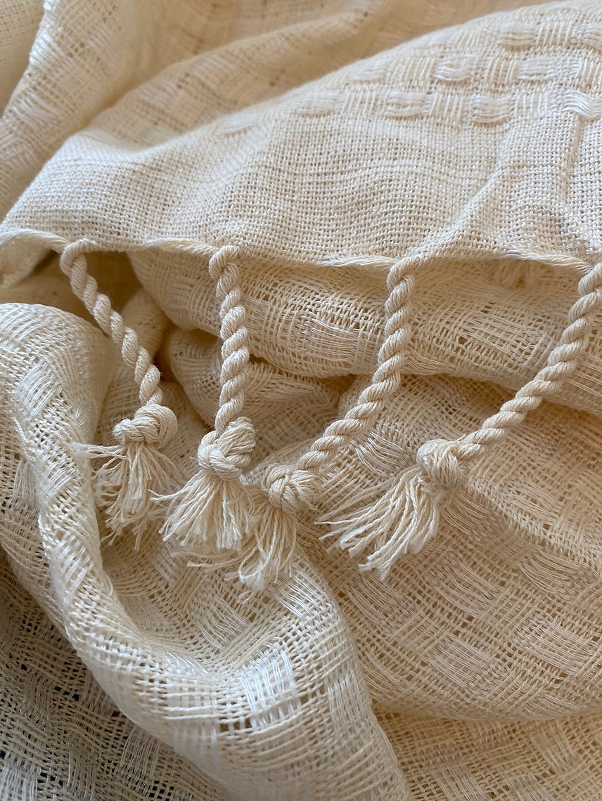 Beige textured fabric with tassels