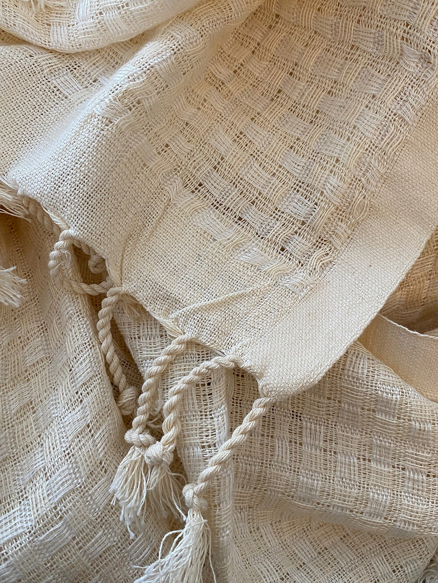 Close-up of beige fabric with tassels