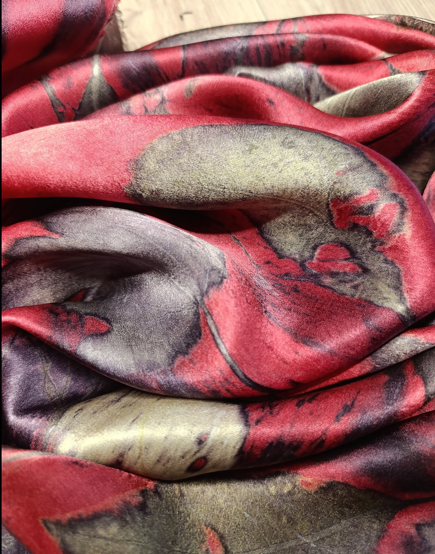 Folded fabric with red, gray, and black pattern