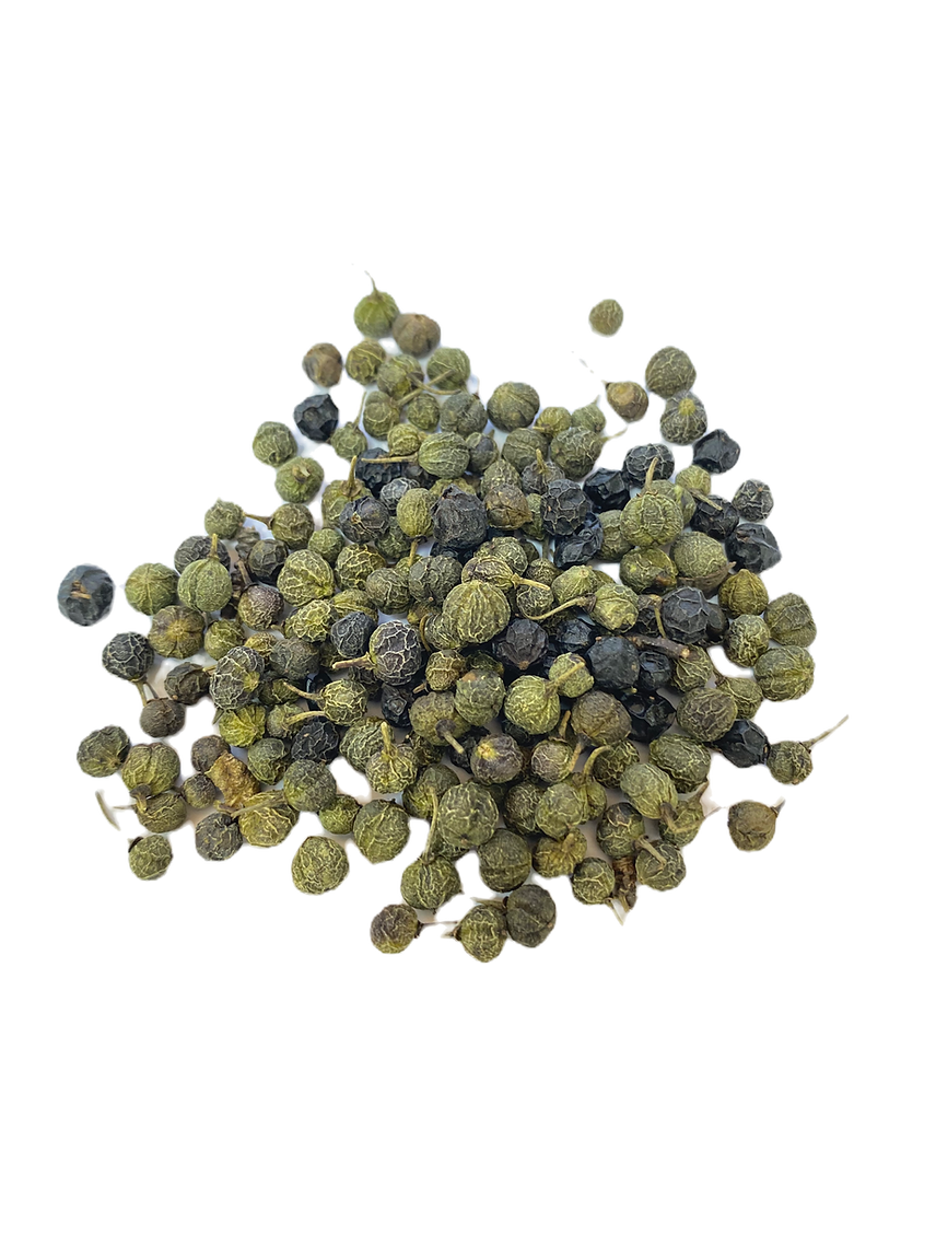Pile of green and black peppercorns on a white background