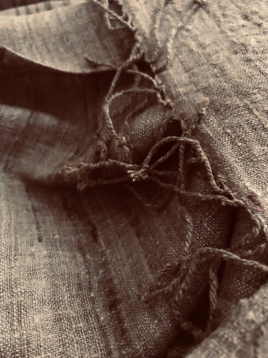 Close-up of textured brown silk scarf with visible stitching
