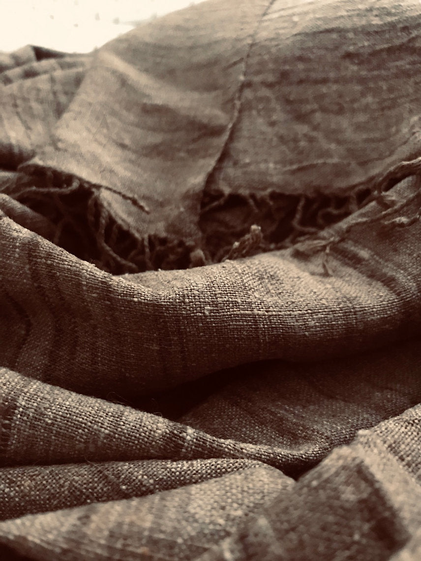 Close-up of textured brown silk scarf with folds