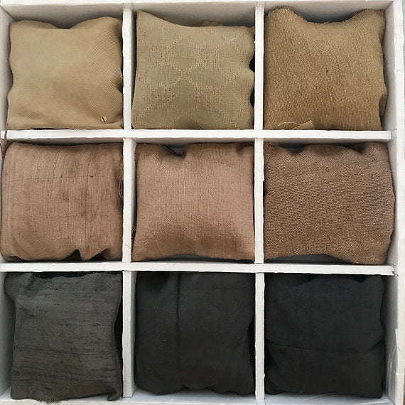 Nine fabric bags in various brown and black shades arranged in a grid.