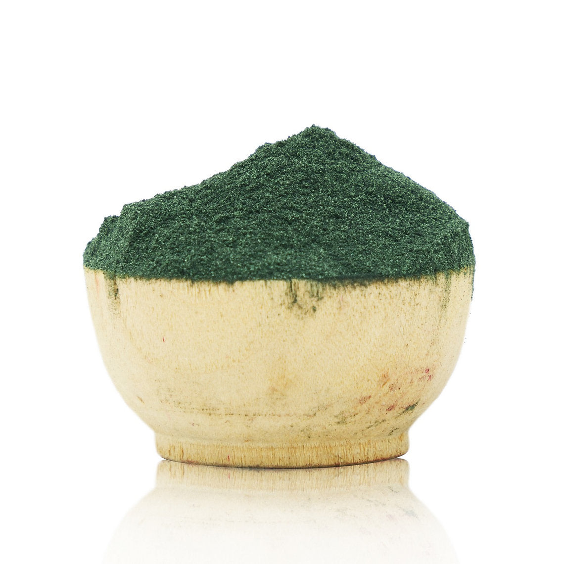 Wooden bowl filled with green powder on a white background