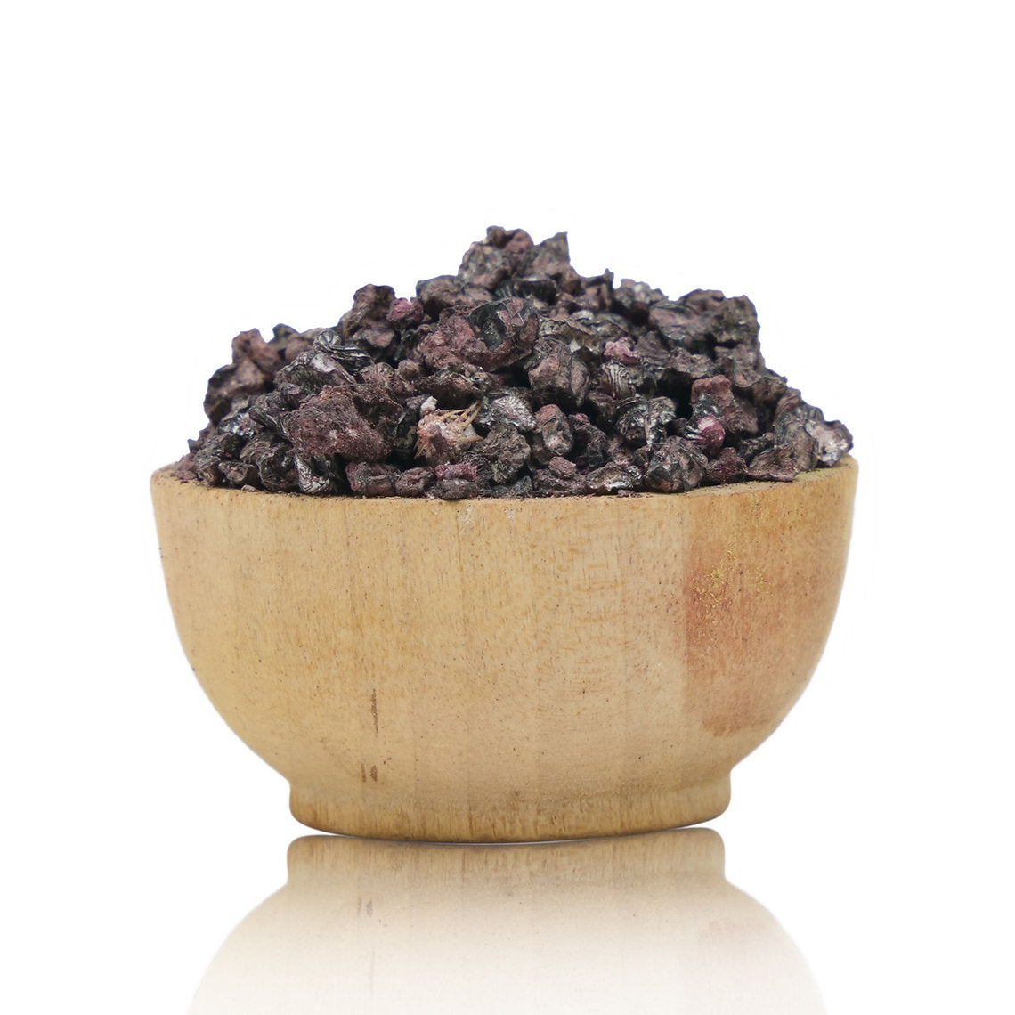 Wooden bowl filled with dark-colored stones on a white background