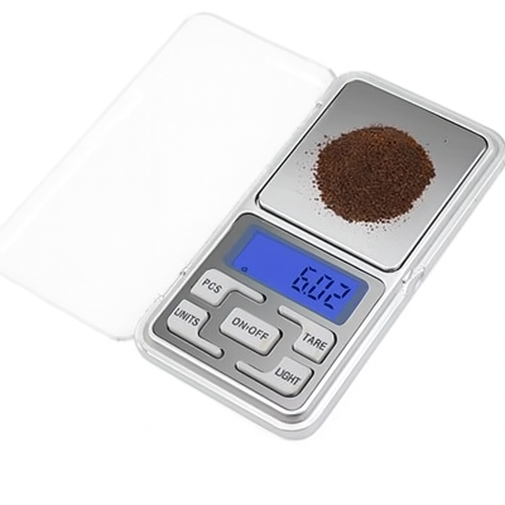 Digital pocket scale with a small amount of cochineal on a white background
