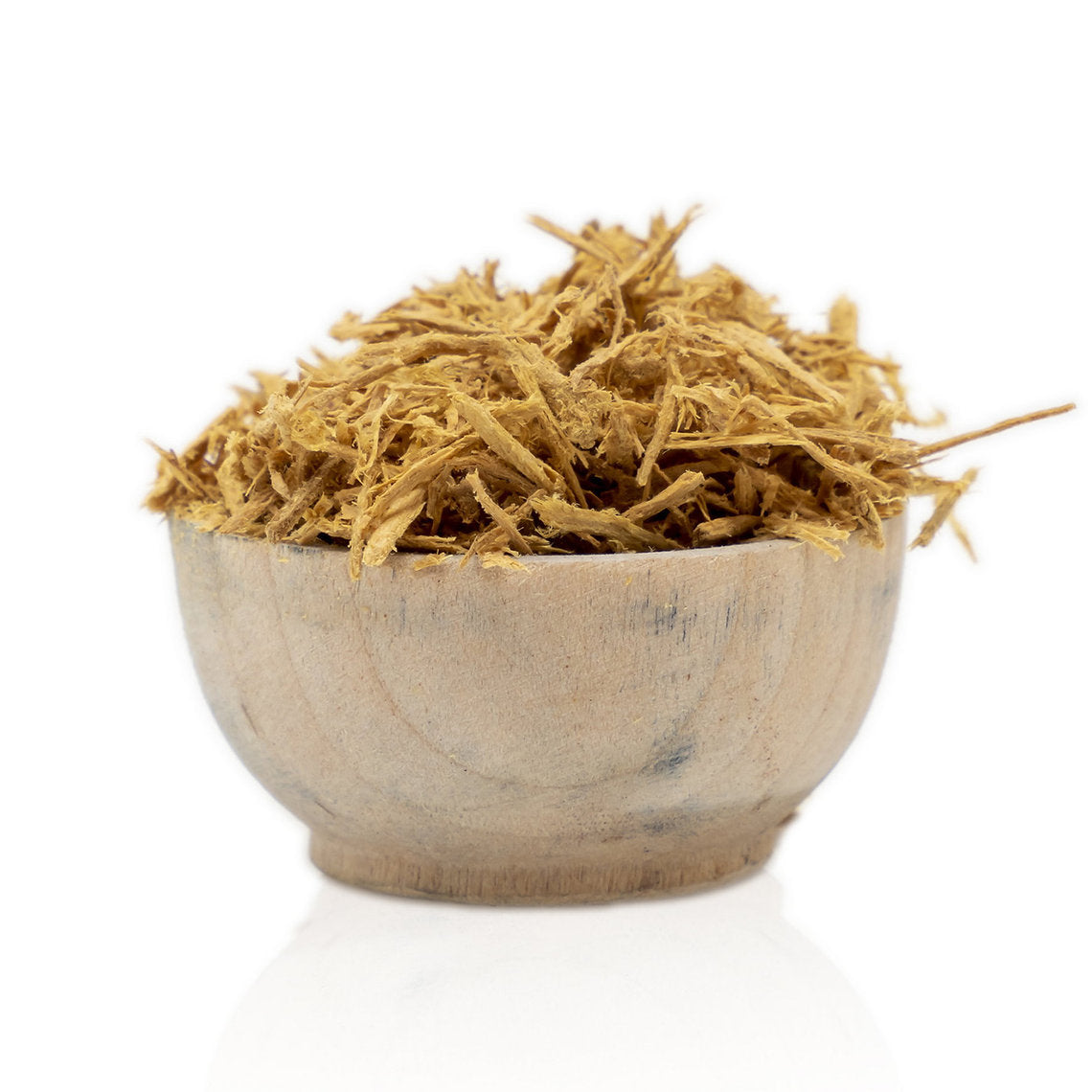 Wooden bowl filled with dried Fustic Heartwood Chips (Chlorophora tinctoria) on a white background