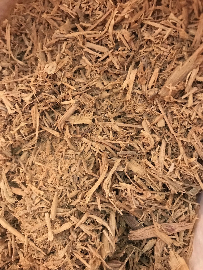 Close-up of dried Fustic Heartwood Chips (Chlorophora tinctoria) spices with a brown color.