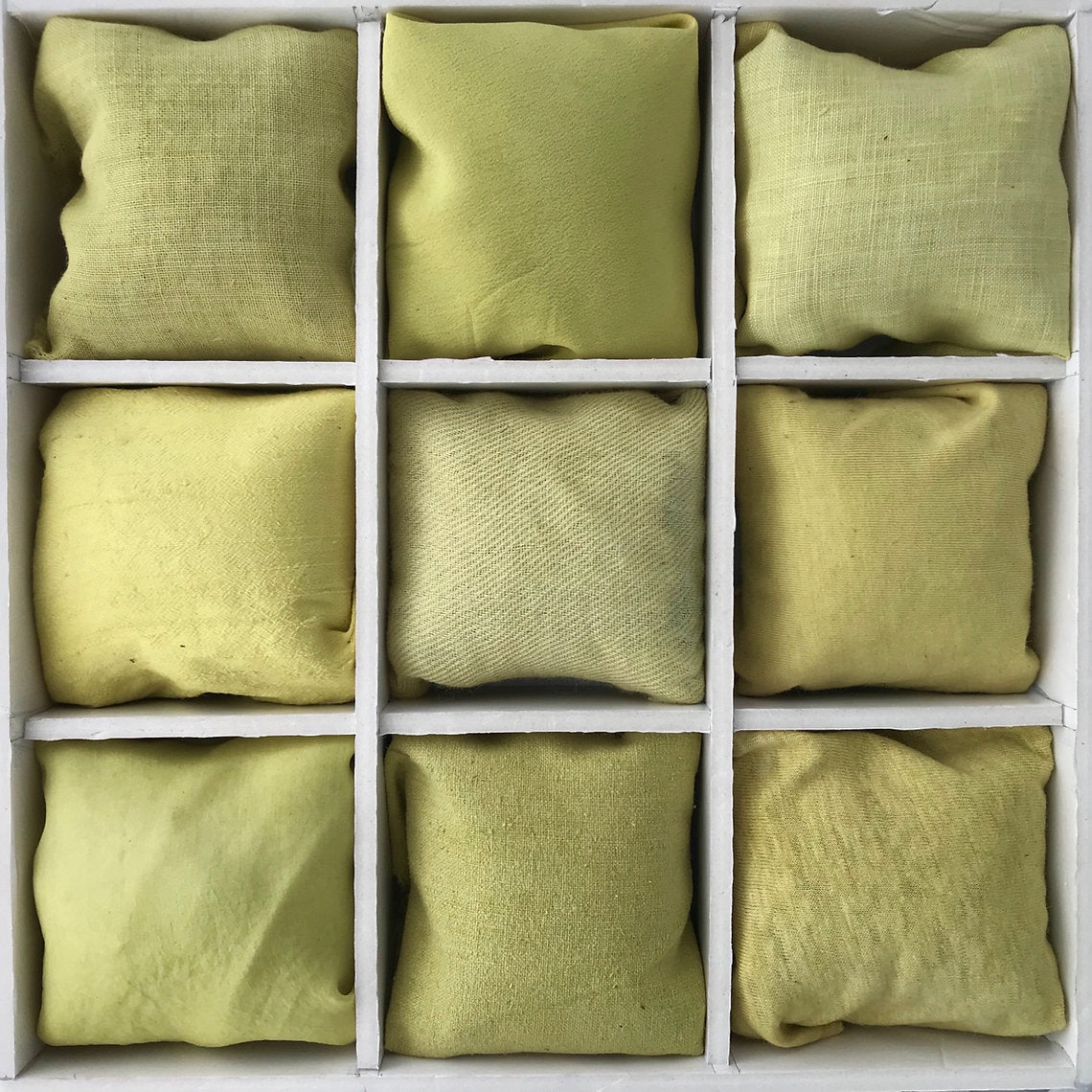 Nine green fabrics dyed Goldenrod Cut Tops (Solidago virgaurea) arranged in a 3x3 grid on a white background