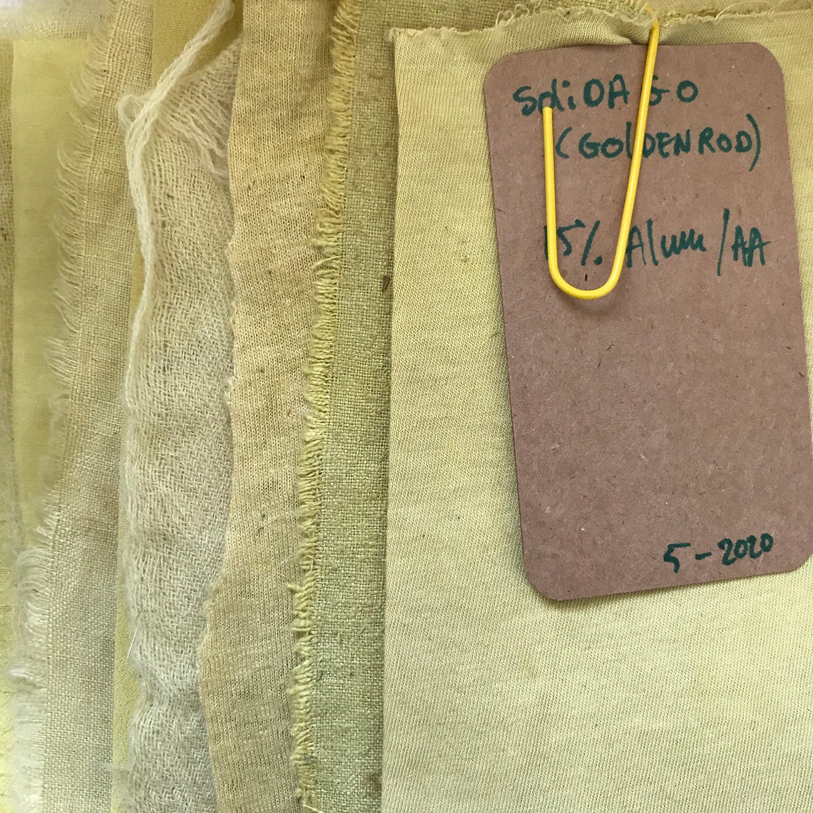 Textile sample dyed Goldenrod Cut Tops (Solidago virgaurea)  with a label indicating color and composition details.