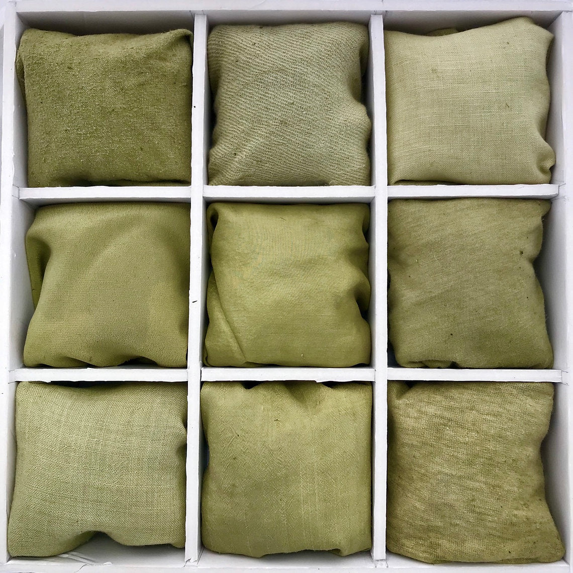 Nine green fabrics dyes Goldenrod Cut Tops (Solidago virgaurea)  arranged in a 3x3 grid on a white background