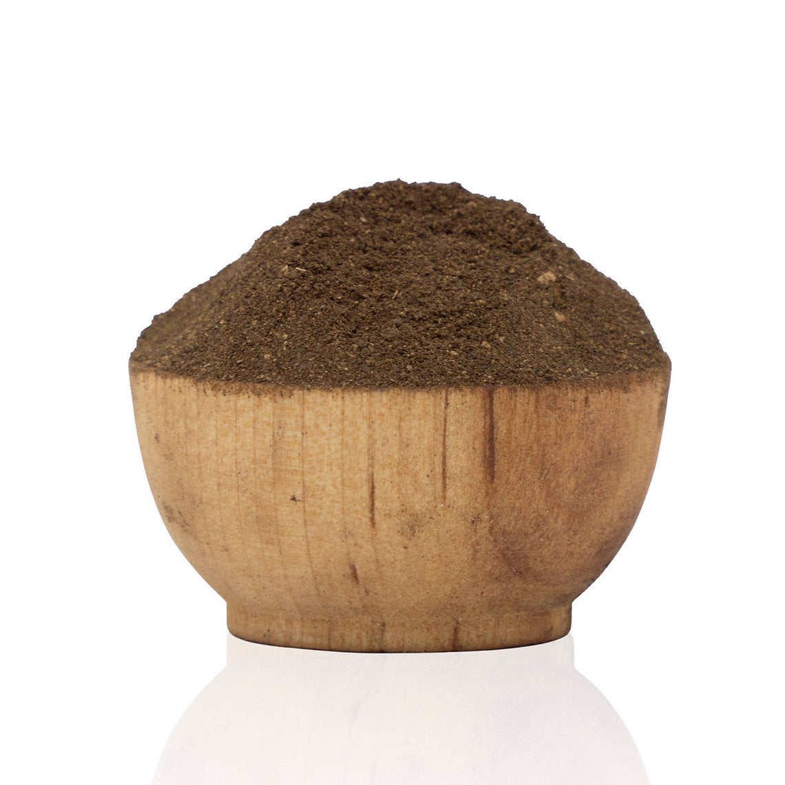 Wooden bowl filled with dark brown powder on a white background