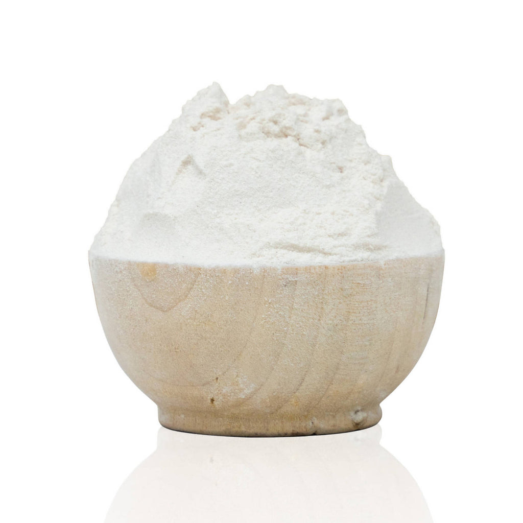 White Gum Arabic, natural thickener, organic powder in a stone bowl on a white background