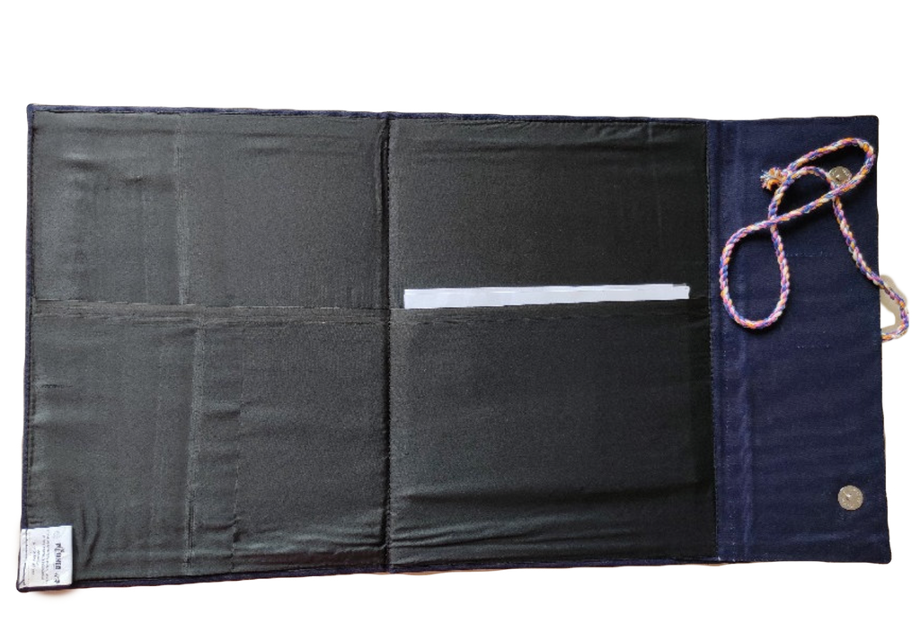 Black and navy fabric roll-up with a rope handle on a white background