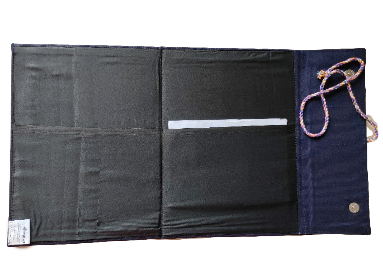 Black and navy fabric roll-up with a rope handle on a white background