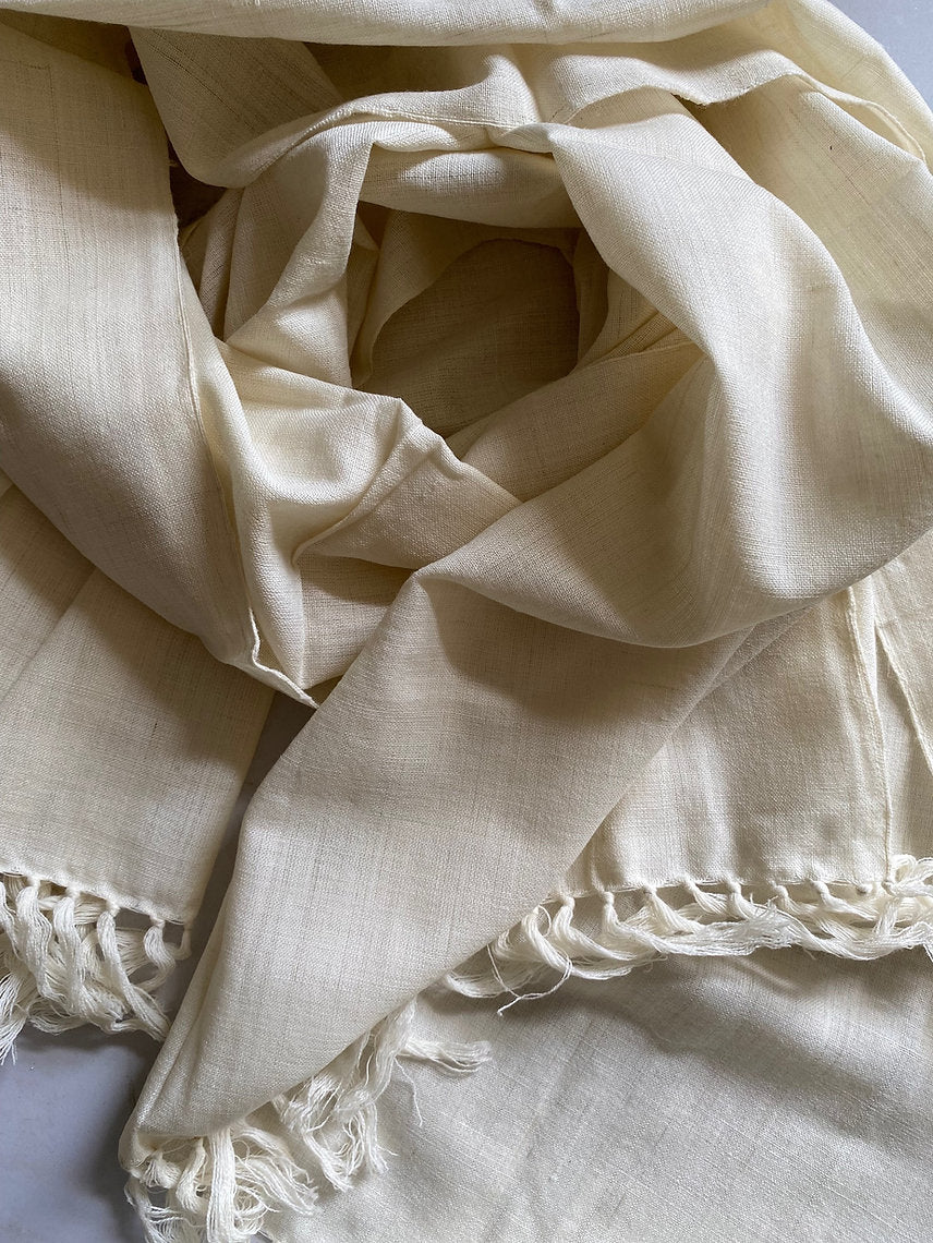 Beige fabric with frayed edges on a light background