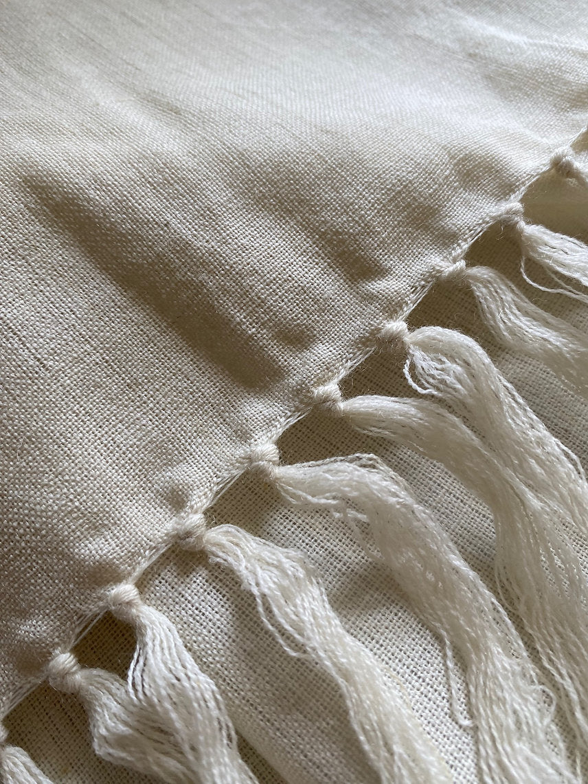 Close-up of a beige fabric with tassels