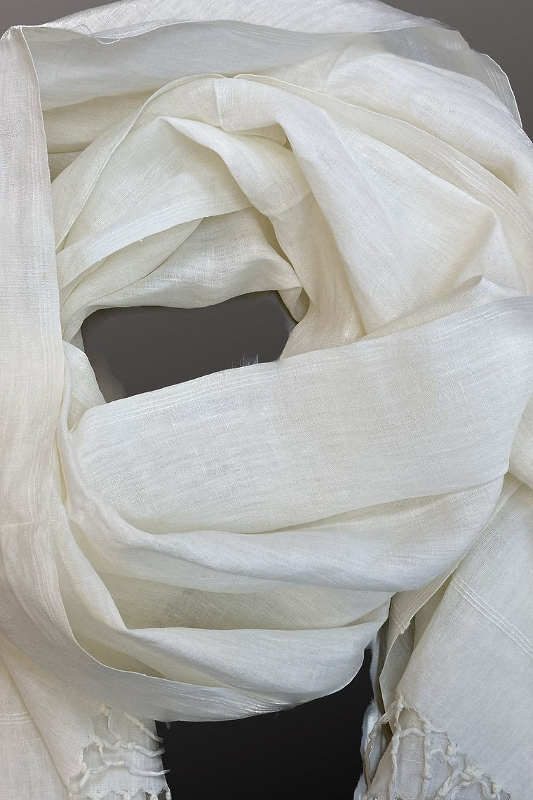 White scarf draped over a dark background