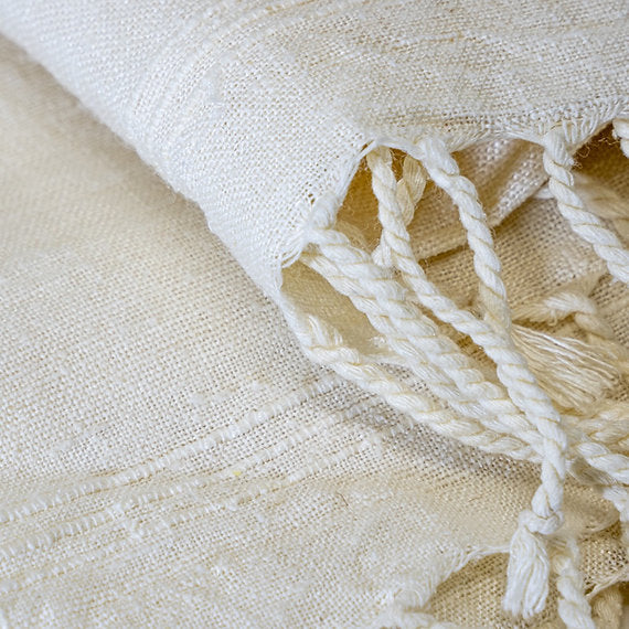 Close-up of beige fabric with tassels