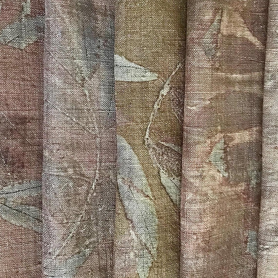 Close-up of fabric with a leaf pattern in earthy tones.