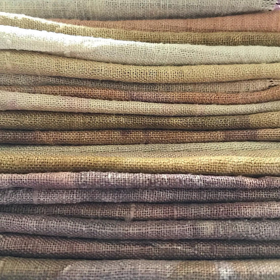Stack of fabric swatches in earthy tones