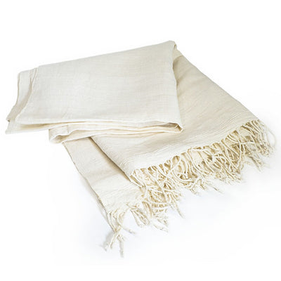 Beige towel with fringes on a white background
