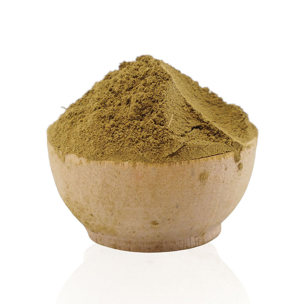 Bowl filled with green powder on a white background