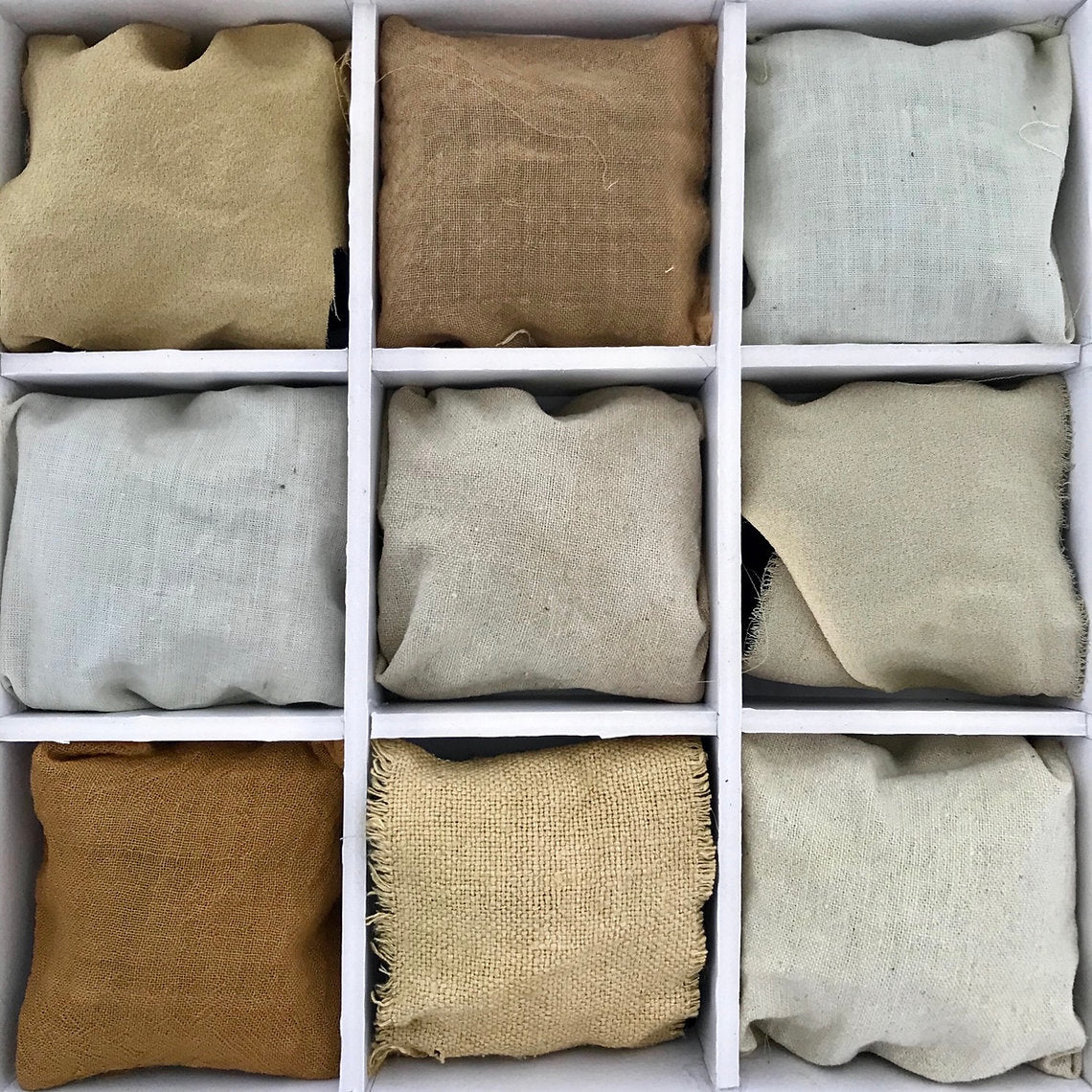 Grid of fabric swatches in various neutral colors.