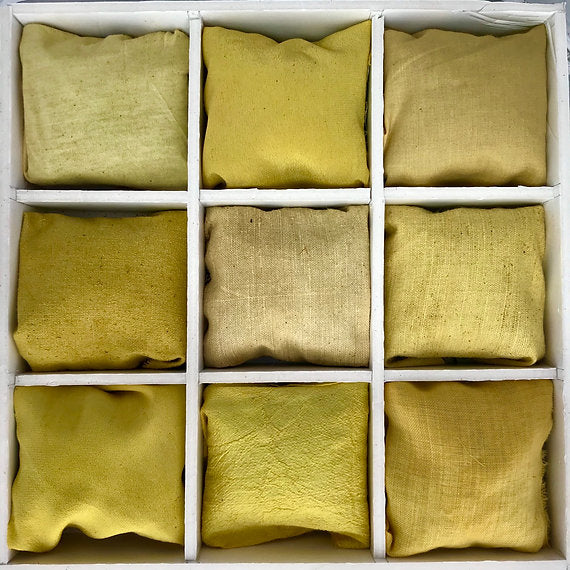 Nine square compartments filled with green fabric in a grid pattern.