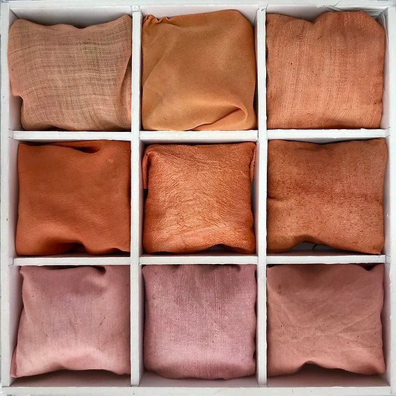 Nine folded fabric swatches in shades of brown and pink arranged in a grid on a white background.