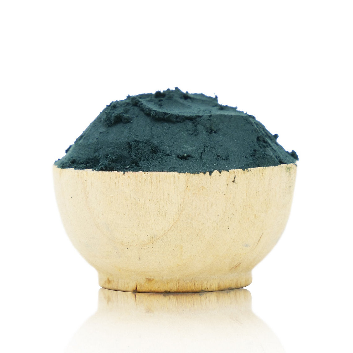 Wooden bowl filled with green powder on a white background