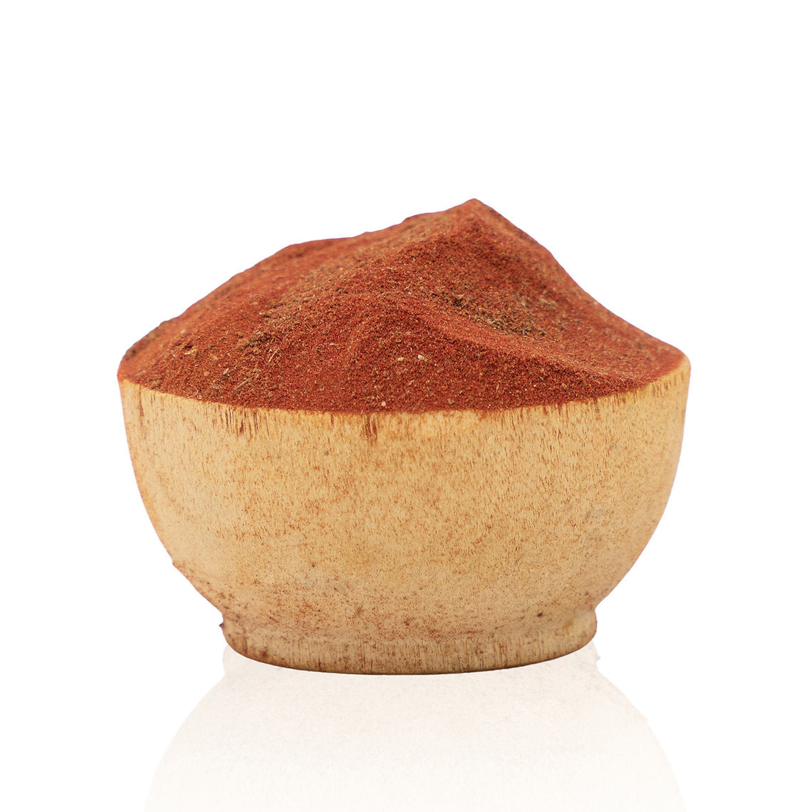 Wooden bowl filled with red Kamala (Mallotus philippinensis) powder on a white background